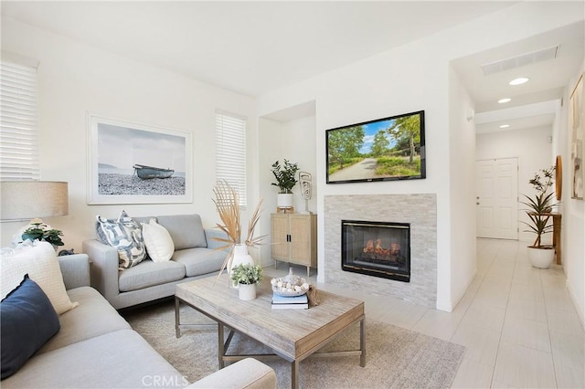 tiled living room featuring a tile fireplace