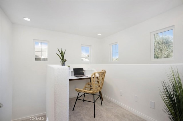 carpeted home office featuring a wealth of natural light