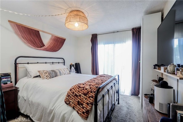 bedroom featuring carpet floors and a textured ceiling