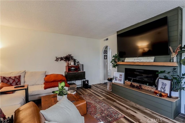 living room with hardwood / wood-style flooring and a textured ceiling