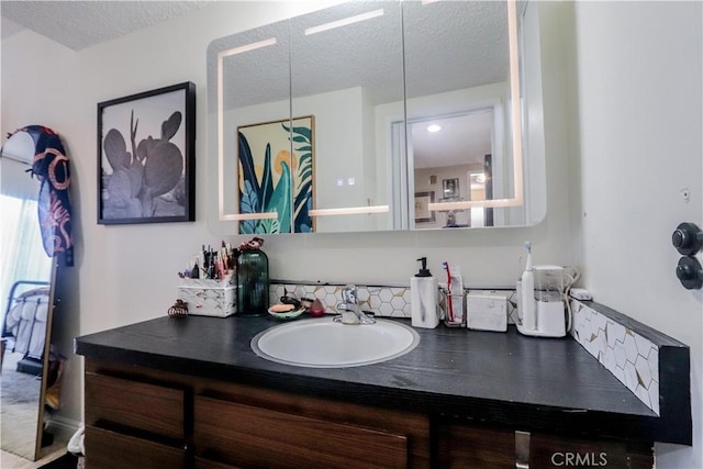 bathroom with vanity and a textured ceiling