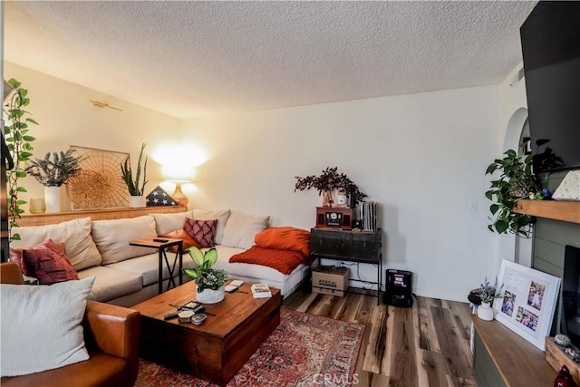 living room featuring a textured ceiling and dark hardwood / wood-style flooring