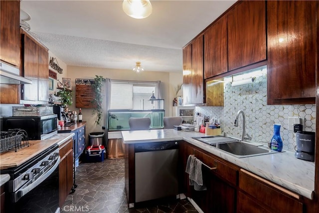 kitchen with sink, decorative backsplash, stove, stainless steel dishwasher, and kitchen peninsula