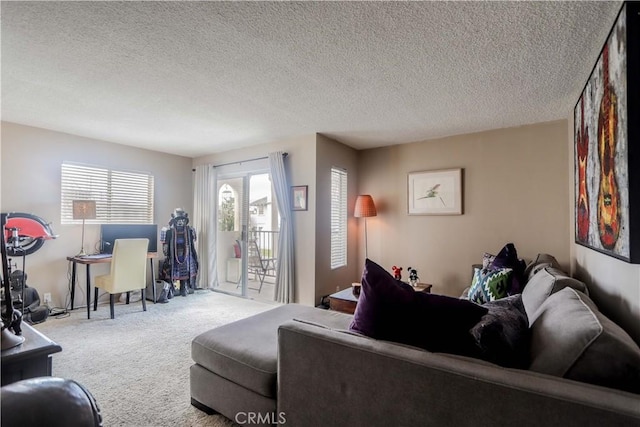 carpeted living room featuring a textured ceiling