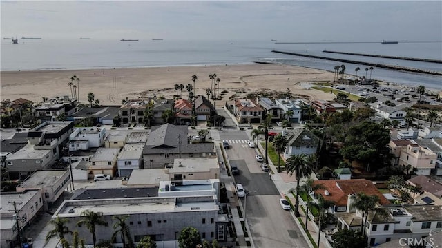 drone / aerial view featuring a view of the beach and a water view