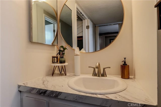 bathroom with vanity and a textured ceiling