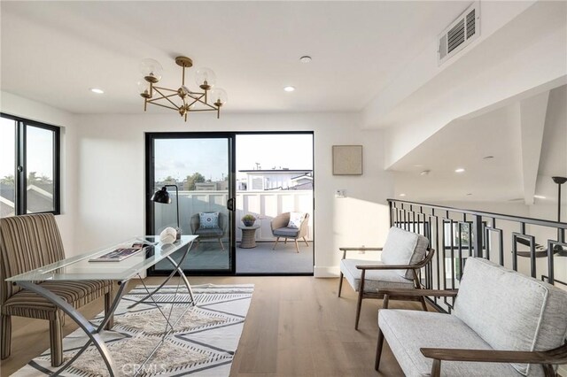 interior space featuring a chandelier and light hardwood / wood-style flooring