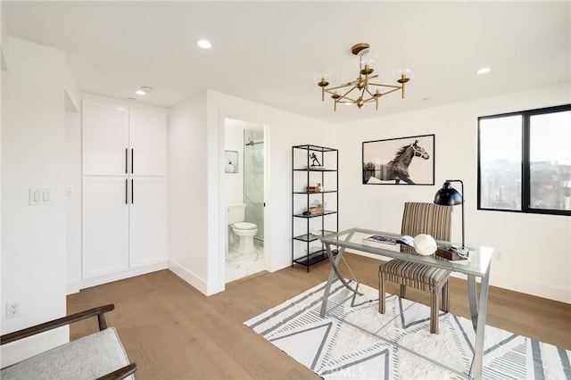 office with an inviting chandelier and light hardwood / wood-style floors