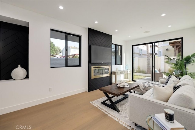 living room featuring a wealth of natural light and light hardwood / wood-style floors