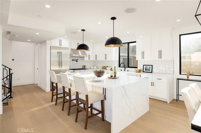 kitchen featuring appliances with stainless steel finishes, a center island, and white cabinets