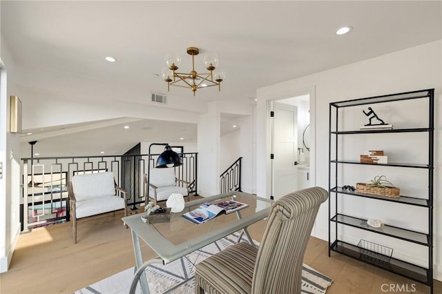 office area with a notable chandelier and light hardwood / wood-style floors