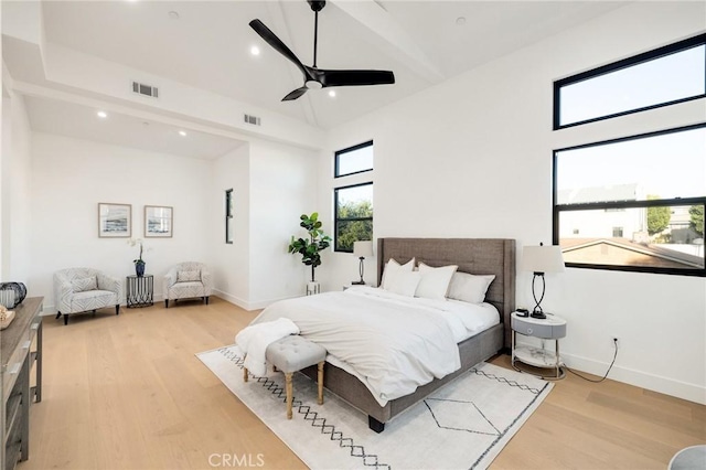 bedroom with ceiling fan, high vaulted ceiling, and light wood-type flooring