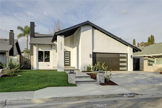 contemporary home with a garage and a front lawn