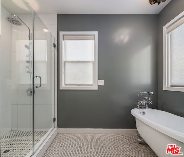 bathroom featuring tile patterned floors and independent shower and bath