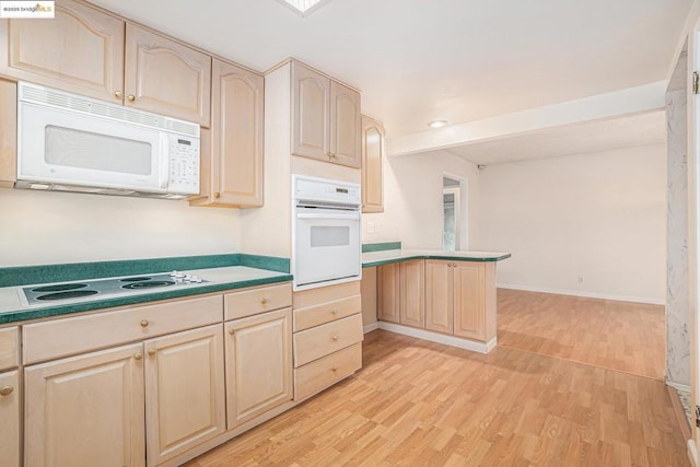 kitchen featuring white appliances, kitchen peninsula, light hardwood / wood-style flooring, and light brown cabinets