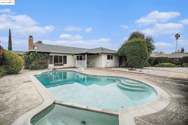 view of swimming pool featuring a diving board and a patio area