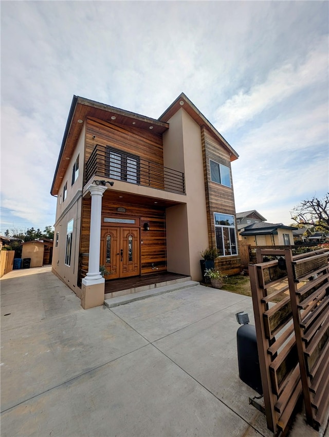 view of front of home featuring a balcony and stucco siding