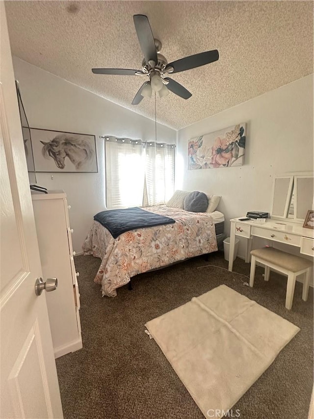 bedroom with ceiling fan, dark carpet, vaulted ceiling, and a textured ceiling