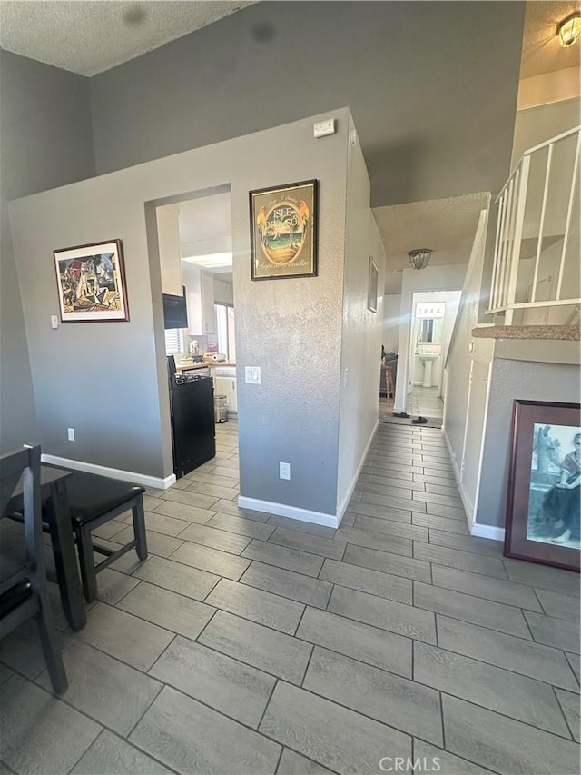 hall featuring a textured ceiling