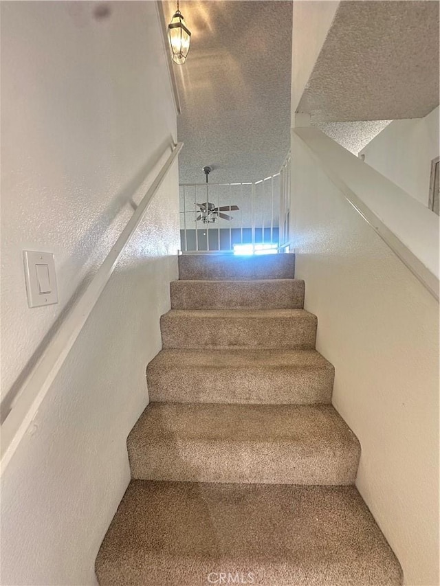 staircase with ceiling fan