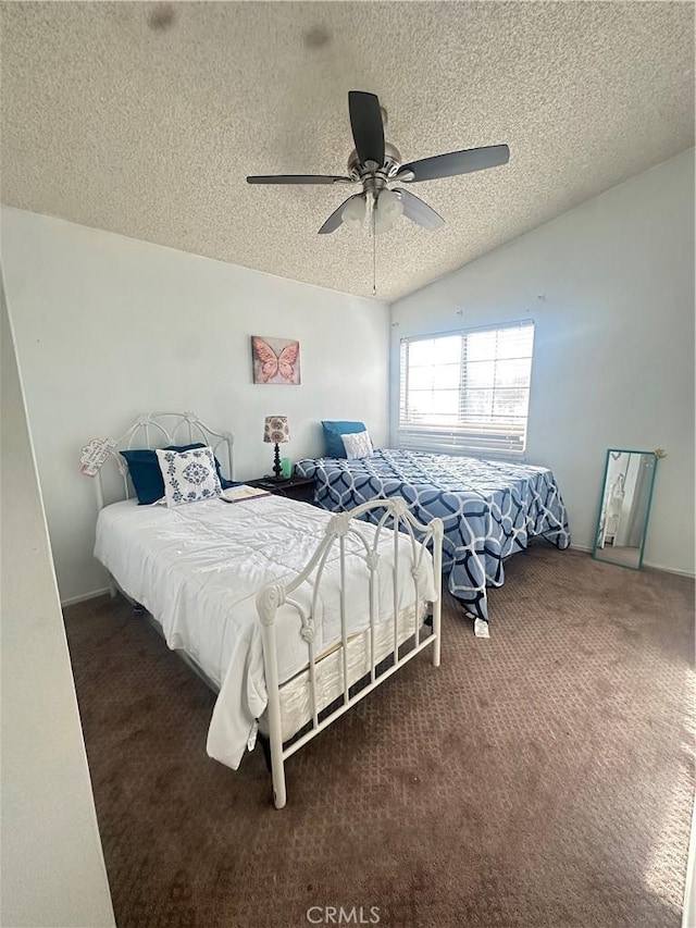 bedroom featuring vaulted ceiling, ceiling fan, a textured ceiling, and dark carpet