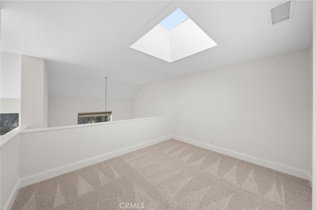 additional living space with lofted ceiling with skylight, carpet, visible vents, and baseboards