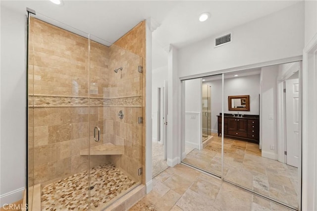 bathroom featuring a stall shower, stone tile floors, visible vents, baseboards, and recessed lighting