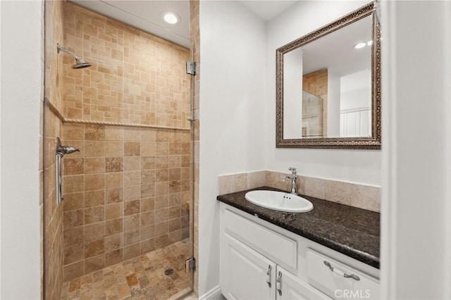 full bath with a shower stall and vanity