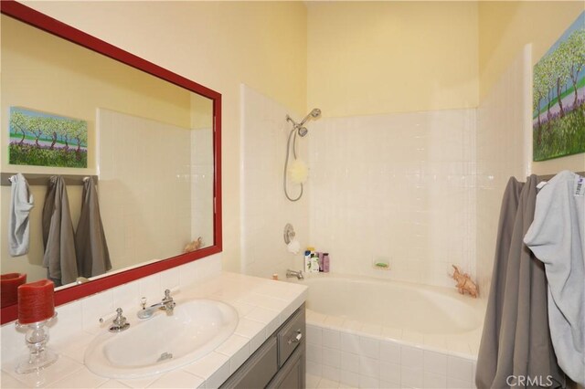 full bathroom with tiled shower / bath and vanity