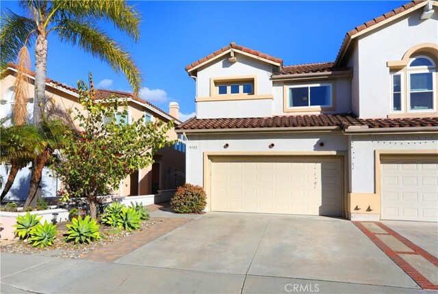 mediterranean / spanish house featuring a garage