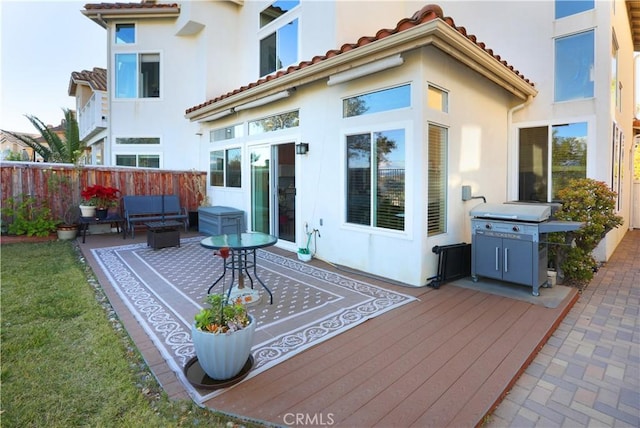 rear view of house featuring a wooden deck and outdoor lounge area