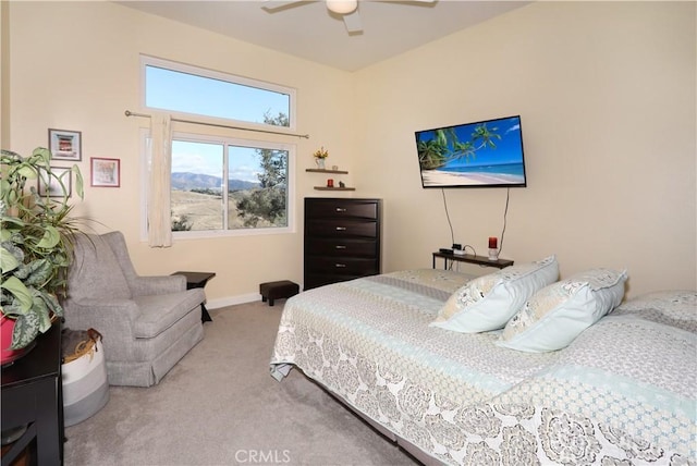 carpeted bedroom with a ceiling fan and baseboards