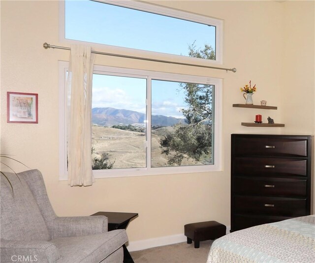 bedroom featuring a mountain view and carpet flooring