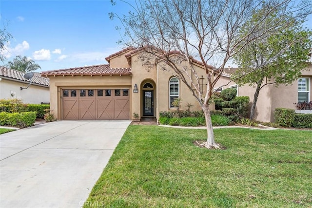 mediterranean / spanish house with a garage, driveway, a tiled roof, stucco siding, and a front yard