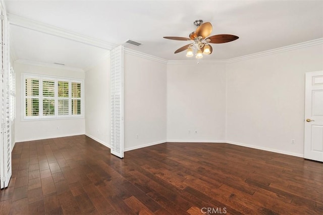 empty room with baseboards, visible vents, ceiling fan, ornamental molding, and wood finished floors