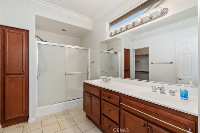 full bath featuring ornamental molding, a stall shower, a sink, and tile patterned floors