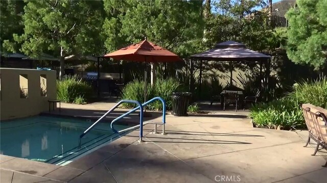 view of swimming pool with a patio, a gazebo, and a swimming pool