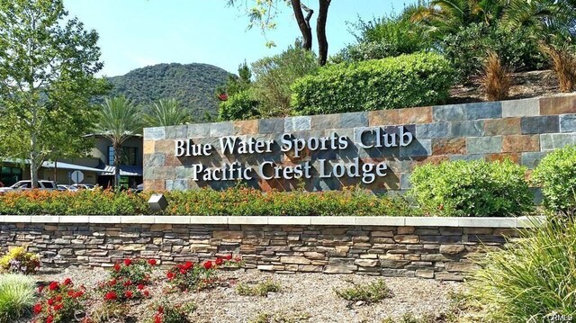 community sign with a mountain view