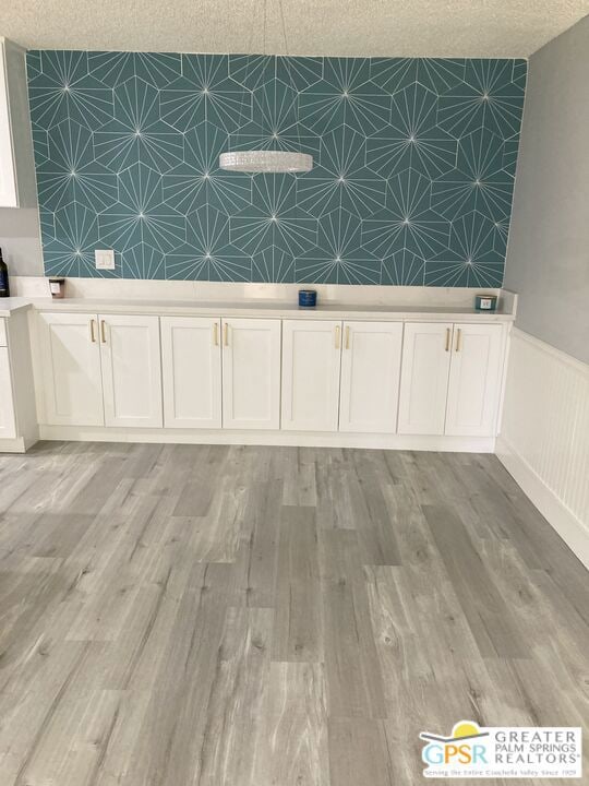 room details featuring wood-type flooring and a textured ceiling