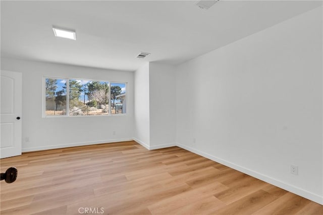 spare room with light hardwood / wood-style flooring