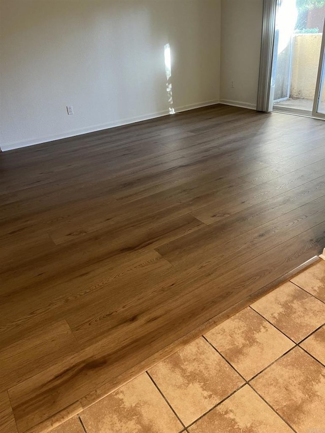 unfurnished room with hardwood / wood-style floors