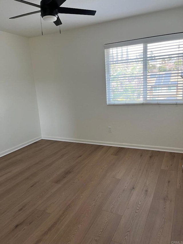 empty room featuring wood-type flooring and ceiling fan