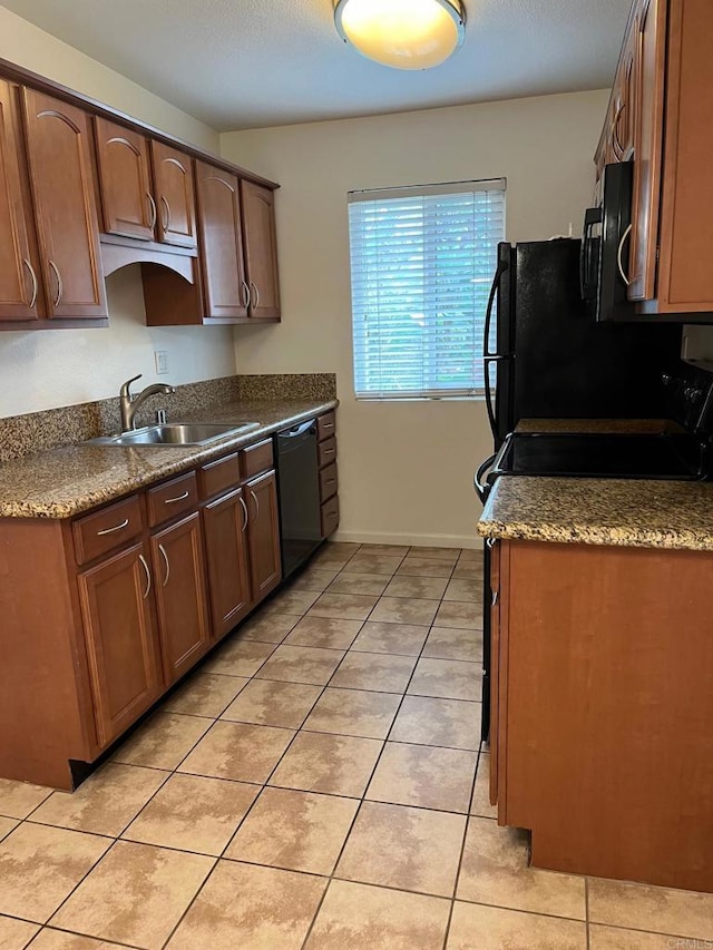 kitchen with light tile patterned flooring, dishwasher, sink, and stove