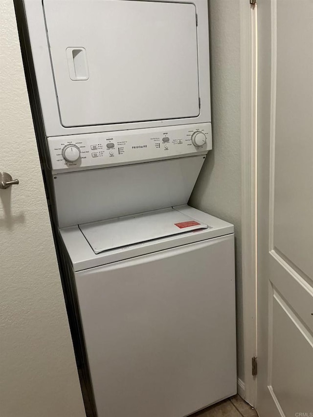 laundry area with stacked washer / dryer