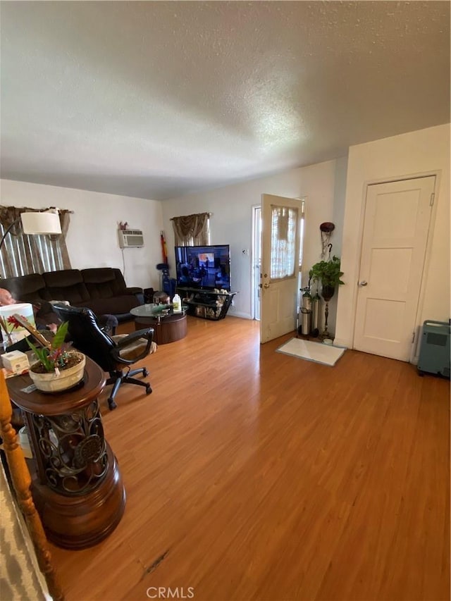 living room with wood-type flooring and a textured ceiling