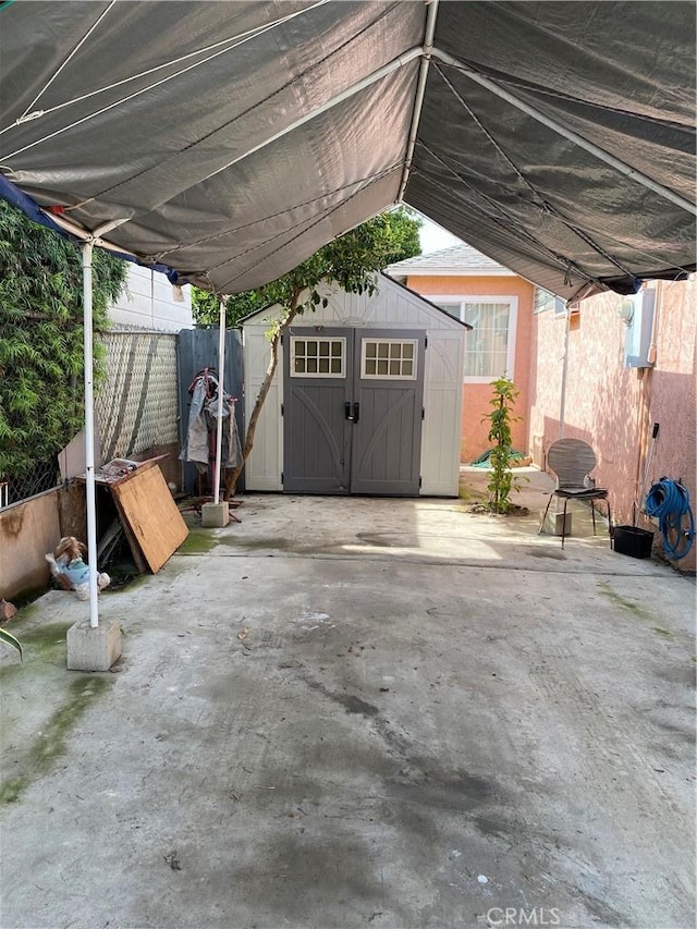 view of patio featuring a shed