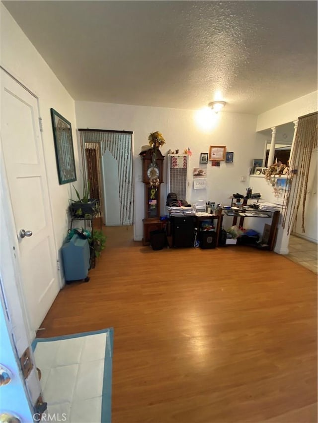 office area featuring hardwood / wood-style flooring and a textured ceiling