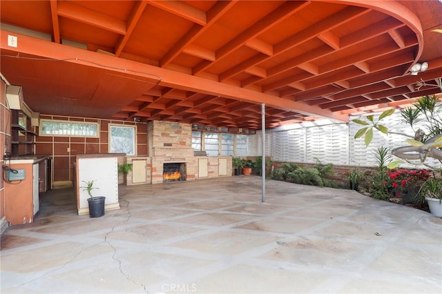 view of patio with an outdoor stone fireplace