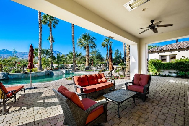 view of patio / terrace with a mountain view, outdoor lounge area, and ceiling fan