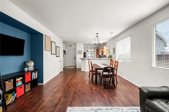 dining area featuring dark hardwood / wood-style floors and a notable chandelier